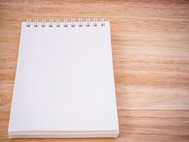 Notepad on the wooden desk table photo