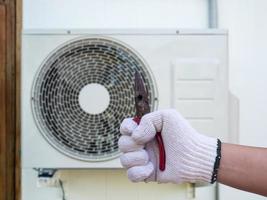 technician installing outdoor air conditioning unit photo