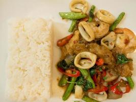 Rice with stir-fried seafood and basil photo