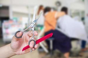 Hairdresser hold scissors with salon beauty background photo