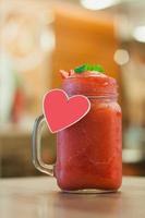 Strawberry smoothie with fresh berries on wood table photo