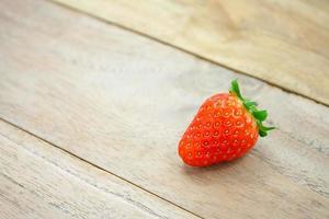 Fresh strawberries on wooden background photo