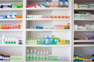 pharmacy store with blur medicines arranged on shelves photo