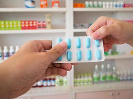 pharmacist giving the patient medicine pills photo