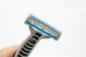 Hand with shaving razor isolated on a white background photo