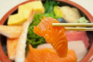 sashimi on the rice in bowl photo