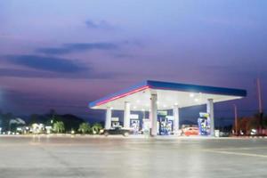 desenfoque de gasolinera con nubes y cielo al atardecer para el fondo foto