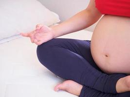 pregnant woman doing yoga photo