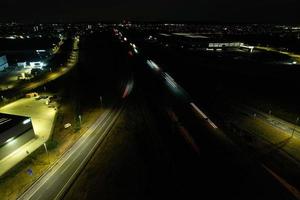 Night Aerial View of British Motorways with illuminated Roads and Traffic. Highways footage taken with drone's camera over Milton Keynes and motorways of England at Dark Night photo