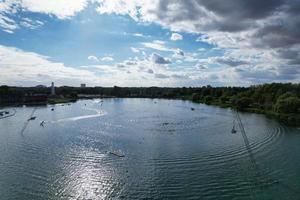 Beautiful Aerial Drone's Camera  Footage of Willen Lake and Park which is located at Milton Keynes, England. People are Enjoying at Lake on a Hot Sunny Day of Summer photo