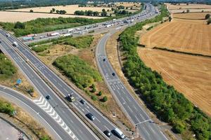 Beautiful Aerial View of British Busy Motorways with Traffic and City on a Sunny Day photo