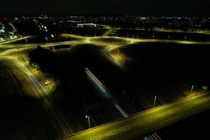 Night Aerial View of British Motorways with illuminated Roads and Traffic. Highways footage taken with drone's camera over Milton Keynes and motorways of England at Dark Night photo