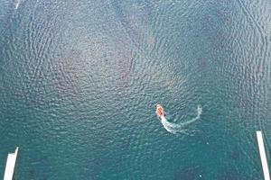 Beautiful Aerial Drone's Camera  Footage of Willen Lake and Park which is located at Milton Keynes, England. People are Enjoying at Lake on a Hot Sunny Day of Summer photo