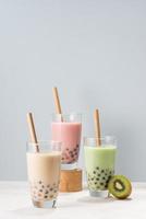 Various Bubble Tea glasses with drink straws isolated on white background.