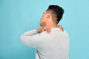 Young attractive man having shoulder pain photo