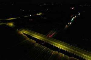 Night Aerial View of British Motorways with illuminated Roads and Traffic. Highways footage taken with drone's camera over Milton Keynes and motorways of England at Dark Night photo