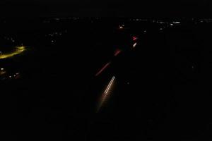 Night Aerial View of British Motorways with illuminated Roads and Traffic. Highways footage taken with drone's camera over Milton Keynes and motorways of England at Dark Night photo