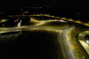 Night Aerial View of British Motorways with illuminated Roads and Traffic. Highways footage taken with drone's camera over Milton Keynes and motorways of England at Dark Night photo