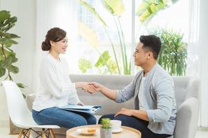 Young Asian female psychologist consulting to her client at her office. photo