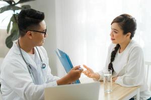 Male Obstetrician-gynecologist working with young stress woman in clinic or hospital healthcare photo