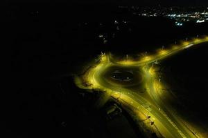 Night Aerial View of British Motorways with illuminated Roads and Traffic. Highways footage taken with drone's camera over Milton Keynes and motorways of England at Dark Night photo