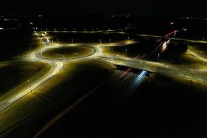 Night Aerial View of British Motorways with illuminated Roads and Traffic. Highways footage taken with drone's camera over Milton Keynes and motorways of England at Dark Night photo