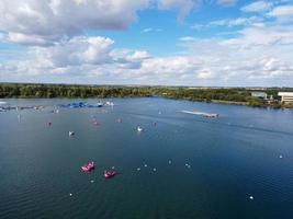 Beautiful Aerial Drone's Camera  Footage of Willen Lake and Park which is located at Milton Keynes, England. People are Enjoying at Lake on a Hot Sunny Day of Summer photo