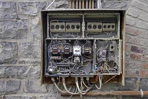 Open fuse box and chaotic cables photo