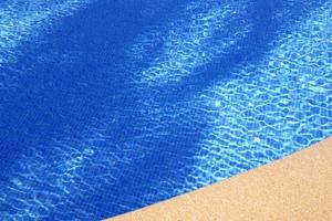 Ripples on the surface of an outdoor pool on a sunny day photo