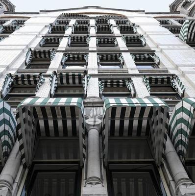 Interesting pattern of windows and blinds on a building exterior in Rotterdam