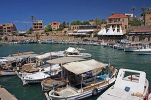 Byblos, Lebanon, 2018 - Boats in the calm water of the port of Byblos, Lebanon, on a sunny day photo