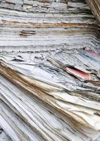Pile of weathered old books and newspapers photo