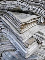 Pile of weathered old books and newspapers photo