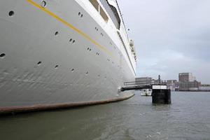 Getting close to a cruise ship with a smaller boat photo