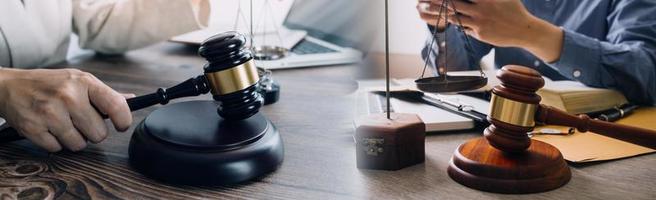 Justice and law concept. Gavel on sounding block in hand's Male judge at a courtroom, working with document law books, report the case on table in modern office. photo