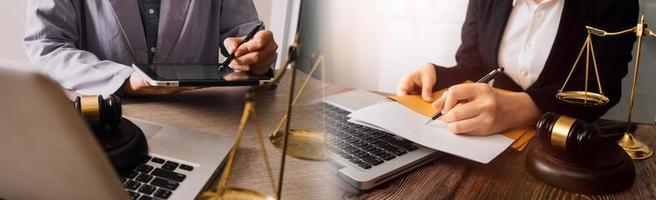 Justice and law concept. Gavel on sounding block in hand's Male judge at a courtroom, working with document law books, report the case on table in modern office. photo