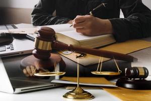 Male lawyer working with contract papers and wooden gavel on tabel in courtroom. justice and law ,attorney, court judge, concept. photo