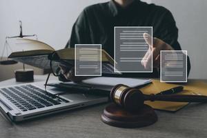 Male lawyer working with contract papers and wooden gavel on tabel in courtroom. justice and law ,attorney, court judge, concept. photo