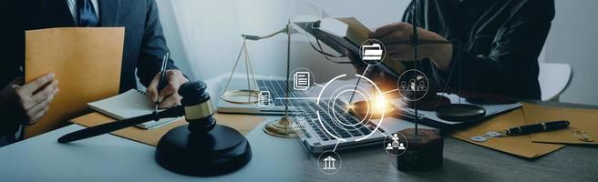 Justice and law concept. Gavel on sounding block in hand's Male judge at a courtroom, working with document law books, report the case on table in modern office. photo