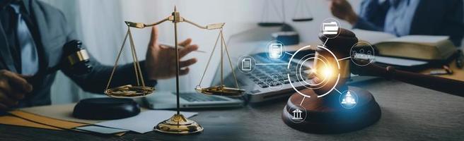 Justice and law concept. Gavel on sounding block in hand's Male judge at a courtroom, working with document law books, report the case on table in modern office. photo