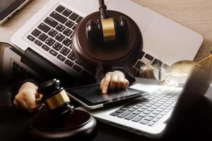 Male lawyer working with contract papers and wooden gavel on tabel in courtroom. justice and law ,attorney, court judge, concept. photo