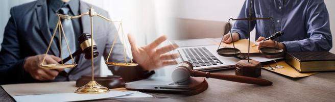 Justice and law concept. Gavel on sounding block in hand's Male judge at a courtroom, working with document law books, report the case on table in modern office. photo
