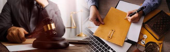 Justice and law concept. Gavel on sounding block in hand's Male judge at a courtroom, working with document law books, report the case on table in modern office. photo