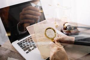 Business and lawyers discussing contract papers with brass scale on desk in office. Law, legal services, advice, justice and law concept picture with film grain effect photo