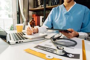 Medicine doctor hand working on a patients x-ray scans digital healthcare and connection with modern virtual screen interface icons, Medical technology and network concept. photo