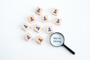 Human resources management and recruitment business hiring concept, professional staff research, head hunter job with magnifying glass. magnifying glass looking for employees on wood cube. photo