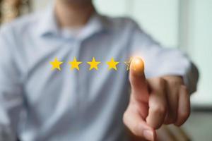 Customer Experience Concept. Review, increase rating or ranking,evaluation and classification concept. Businessman click on five yellow stars to increase rating. photo