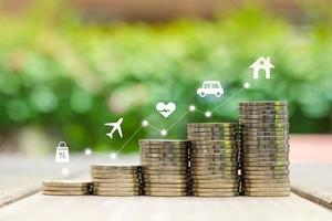 Save money concept. Business investment in the future concept. stack of coin and icon of shopping, plane, healthy, car and house. insurance , travel and plan to retirement. photo