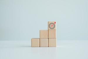 Business strategy, Action plan, Goal and target. dart board symbols on top of wooden block. Goal or agenda setting in business concept. photo