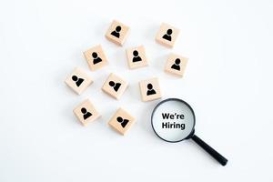 Human resources management and recruitment business hiring concept, professional staff research, head hunter job with magnifying glass. magnifying glass looking for employees on wood cube. photo